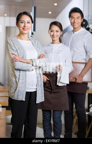 Restaurant owner and wait staff Stock Photo