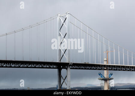 Stunning light on the Forth Road Bridge, with one of the piers of the new Queensferry Crossing in the background, under construction. Stock Photo