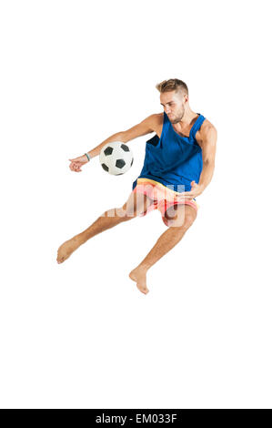 Young attractive guy playing with football on white background Stock Photo