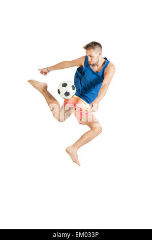 Young attractive guy playing with football on white background Stock Photo