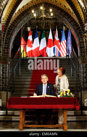 Luebeck, Germany. 15th Apr, 2015. British Foreign Secretary Philip Hammond, left, signs the Golden Book of the city of Luebeck prior to a meeting of the G7 Foreign ministers in Luebeck, northern Germany, Tuesday, April 14, 2015. The meeting is being held ahead of the G7 leaders summit in Germany from June 7 to 8, 2015. Right is city representative Gabriele Schopenhauer. Credit:  dpa picture alliance/Alamy Live News Stock Photo