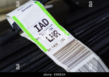 A suitcase with a airline barcode baggage tag from London Heathrow ...