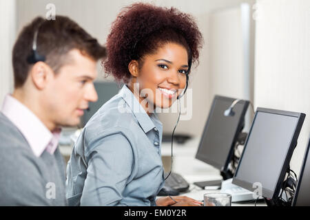 Female Employee Working In Call Center Stock Photo