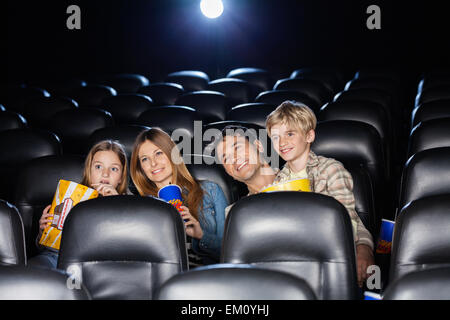 Smiling Family Watching Film In Theater
