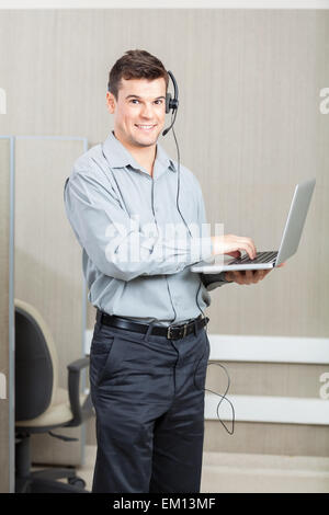 Male Customer Service Representative With Laptop Stock Photo