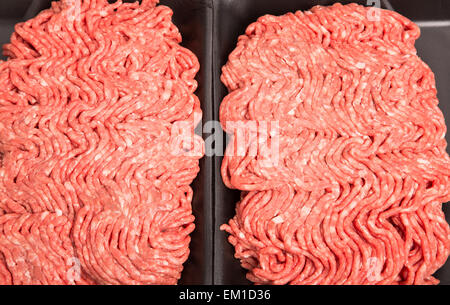 Fresh, raw ground beef in a black, styrene tray Stock Photo