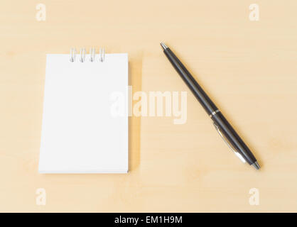 Memo Note Placed on Wooden Texture Background with Black Pen Stock Photo
