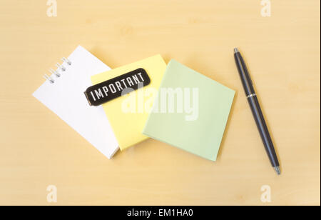 Important Three Colors Paper Notes and Black Pen on Wooden Texture Stock Photo