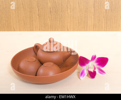 Thai Ceramic Tea Set with Two Cups Placed on Wooden Table with Orchid Flower Stock Photo