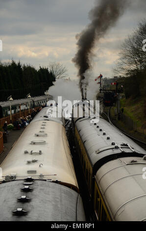 A train pulls out of Bridgnorth Railway Station on the Severn Valley Railway Line. Black smoke and steam pour from the chimney. Stock Photo