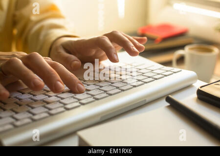 Female secretary inputting data to the office computer. Stock Photo