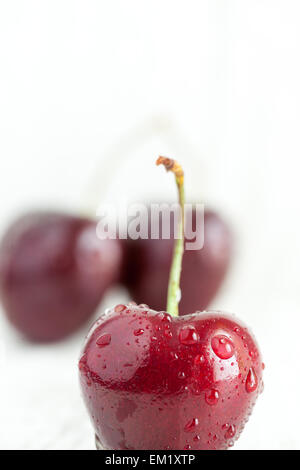 Close-up of a red cherry with droplets of water on it. Stock Photo