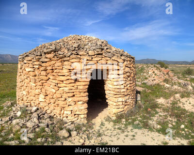 Stone built shepherd's hut in the Alicante region of Spain, used as shelter when moving goats and sheep between grazing areas. Stock Photo