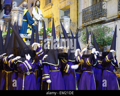 Nazarenos carrying a trono (religious float) in a night time procession during Semana Santa (Holy Week) in Jumilla, Spain Stock Photo