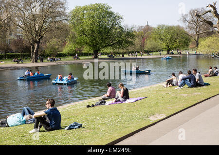 People Sitting by The Boating Lake Regents Park London UK Stock Photo