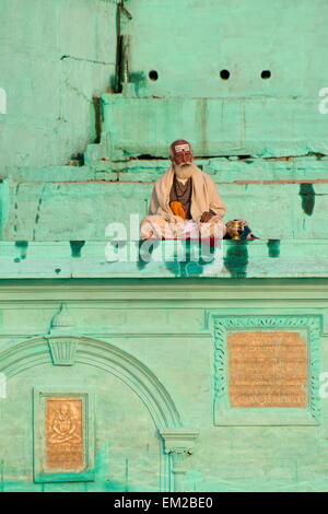 Holy man lingering the ghats of Varanasi Stock Photo