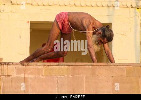 Holy man lingering the ghats of Varanasi Stock Photo