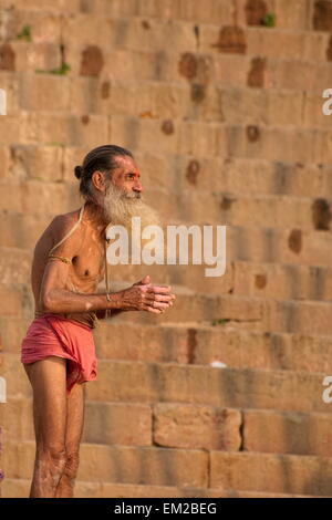 Holy man lingering the ghats of Varanasi Stock Photo