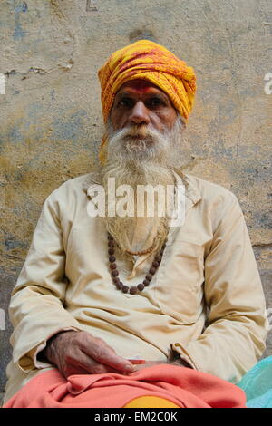 Holy man lingering the ghats of Varanasi Stock Photo