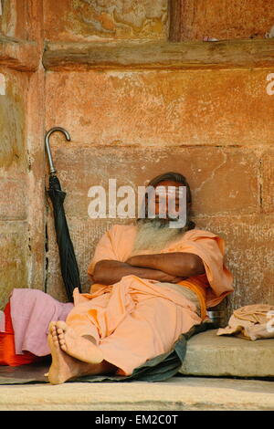 Holy man lingering the ghats of Varanasi Stock Photo