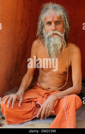 Holy man lingering the ghats of Varanasi Stock Photo