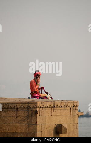 Holy man lingering the ghats of Varanasi Stock Photo