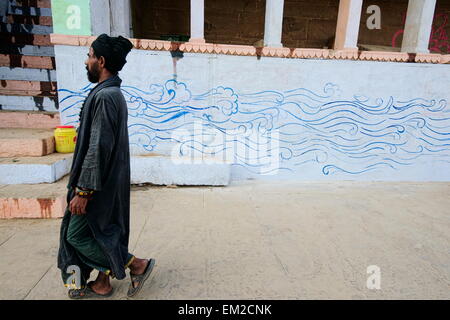 Holy man lingering the ghats of Varanasi Stock Photo