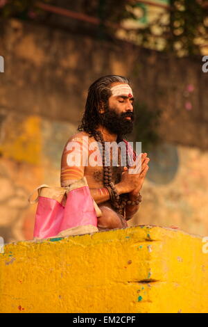 Holy man lingering the ghats of Varanasi Stock Photo