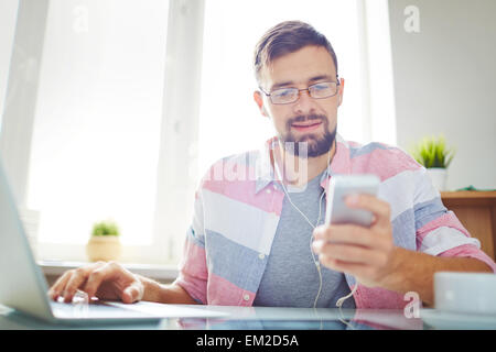 Businessman in casual using smartphone and laptop Stock Photo
