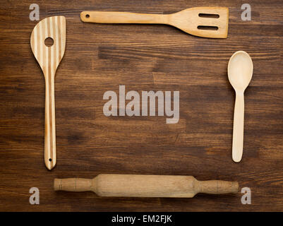 Wooden kitchen tools on vintage wooden background. Top view Stock Photo