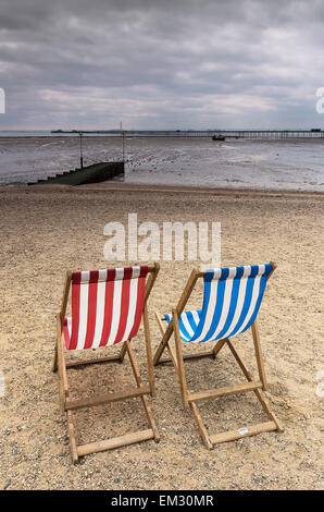 Two empty deckchairs on Jubilee Beach in Southend on a cloudy day. Stock Photo