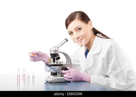 Female doctor or scientific researcher using microscope in a laboratory. Stock Photo