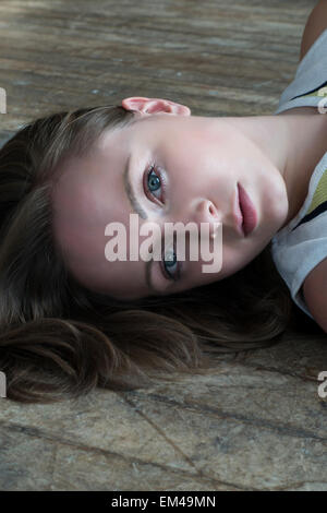 Beautiful young woman lying on the floor Stock Photo