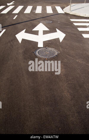 Road markings in the form of arrows on the asphalt road in the city Stock Photo