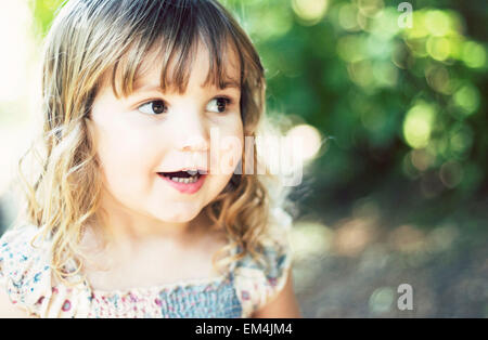 girl, daughter, light, green, blonde brown hair, smiling, happy bokeh Stock Photo