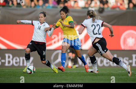 Fuerth, Germany. 8th Apr, 2015. Germany's Babett Peter (l) Brazil's Cristiane (c) in action during the women's international friendly soccer match Germany vs Brazil in Fuerth, Germany, 8 April 2015. Photo: Thomas Eisenhuth/dpa - NO WIRE SERVICE -/dpa/Alamy Live News Stock Photo