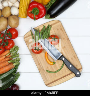 Vegetarian and vegan eating smiling face from vegetables on cutting board with knife Stock Photo