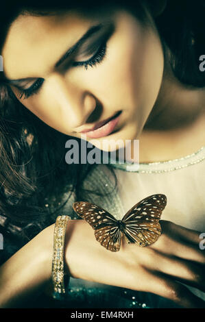 Beautiful young woman with a butterfly Stock Photo