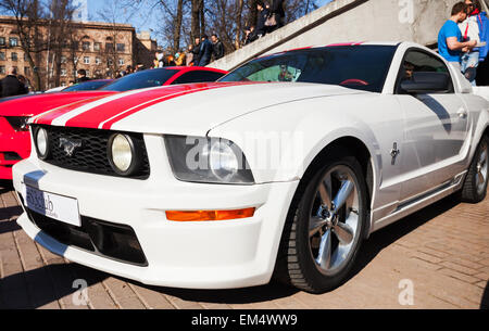 Saint-Petersburg, Russia - April 11, 2015: White Ford Mustang with red stripes stands parked on the city street Stock Photo