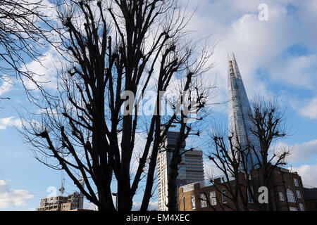 The Shard towering over a council housing estate in Southwark, London, UK. The Shard, also referred to as the Shard of Glass, Shard London Bridge and formerly London Bridge Tower, is an 87-storey skyscraper in London that forms part of the London Bridge Quarter development. Stock Photo