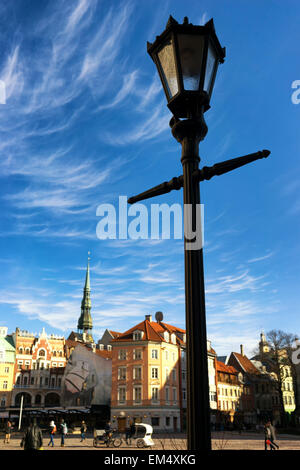 Street lamp in the Dome Square in Riga on the background of medieval buildings and beautiful clouds in early spring. Latvia Stock Photo