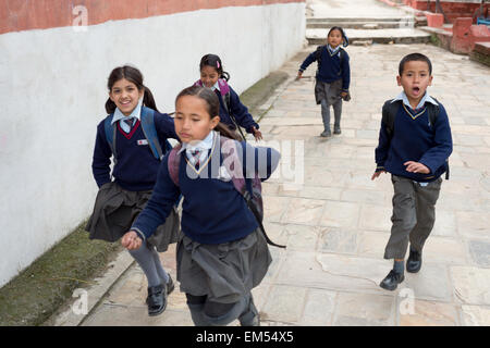 A group of children running back home after school Stock Photo