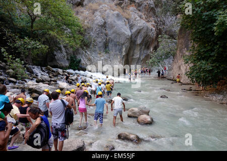 Visitors crossing the river on their way into Saklikent Gorge, Turkey Stock Photo