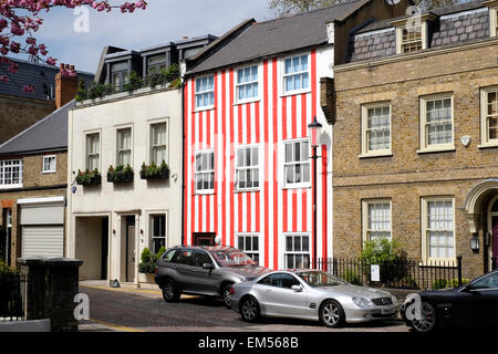 A general view of a house painted in red and white stripes. Stock Photo