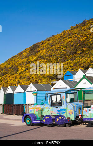 The home of Peppa Pig world - Landtrain on the promenade at Middle Chine, Bournemouth with beach huts in April Stock Photo