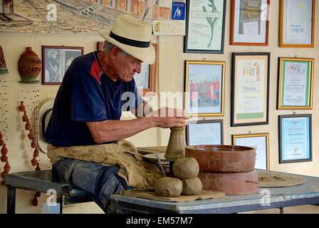 Potter Azariel Santander Alcantera at his wheel in Trinidad, Cuba. One of a few private businesses allowed in the last 50 years. Stock Photo