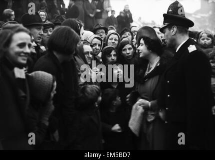 Queen Elizabeth watched by her husband King George VI, talks to a group of people made homeless in one of the mosy heavily raided areas of Sheffield during the war. 6th January 1941. Stock Photo