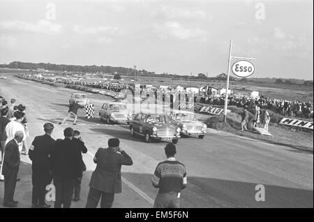 Competitors take the checkered flag in the Molyslip Morris 1100 race at Snetterton race track in Norfolk. September 29th 1963 Stock Photo