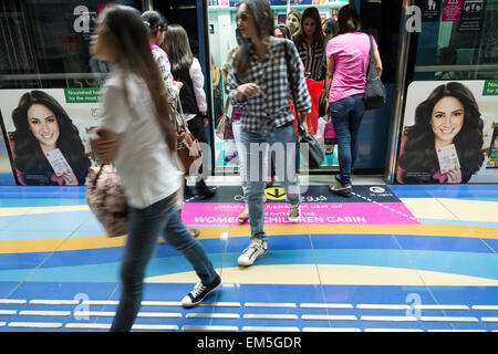 Female passengers exit train from women only carriage on metro train in Dubai United Arab Emirates Stock Photo