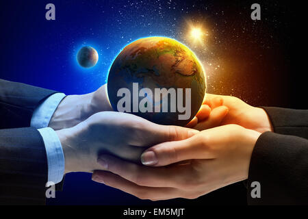Earth planet in hands Stock Photo